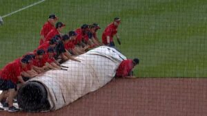 Nats-groundskeeper-slips-rolls-under-tarp_.jpg